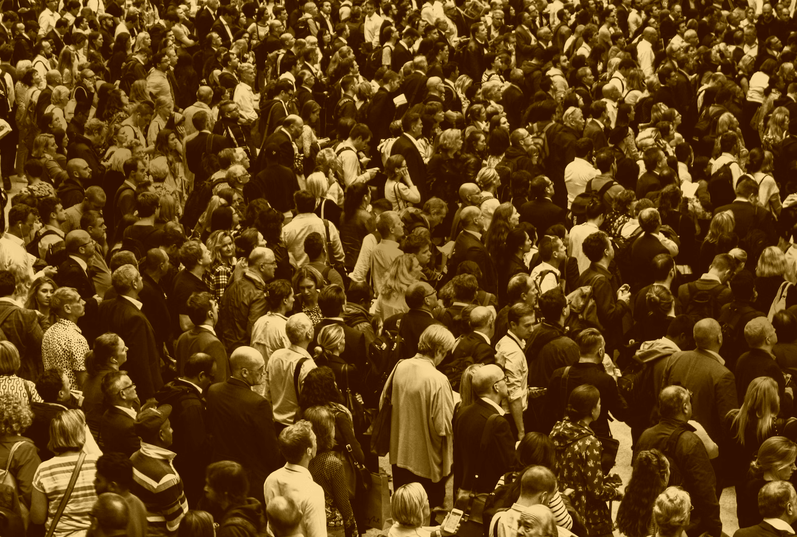 A crowd of people taken with a yellow filter